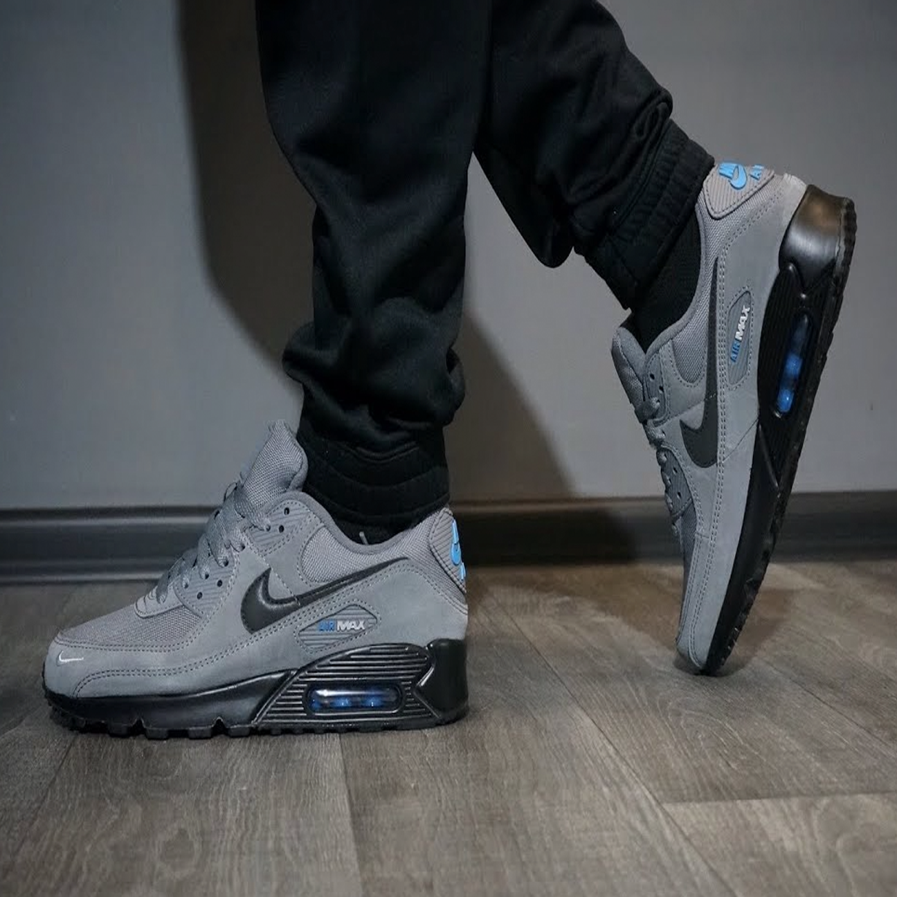 Nike Air Max 90 Smoke Grey Light Photo Blue sneaker with mesh and leather upper blue accents and classic Air Max cushioning available at The Attic