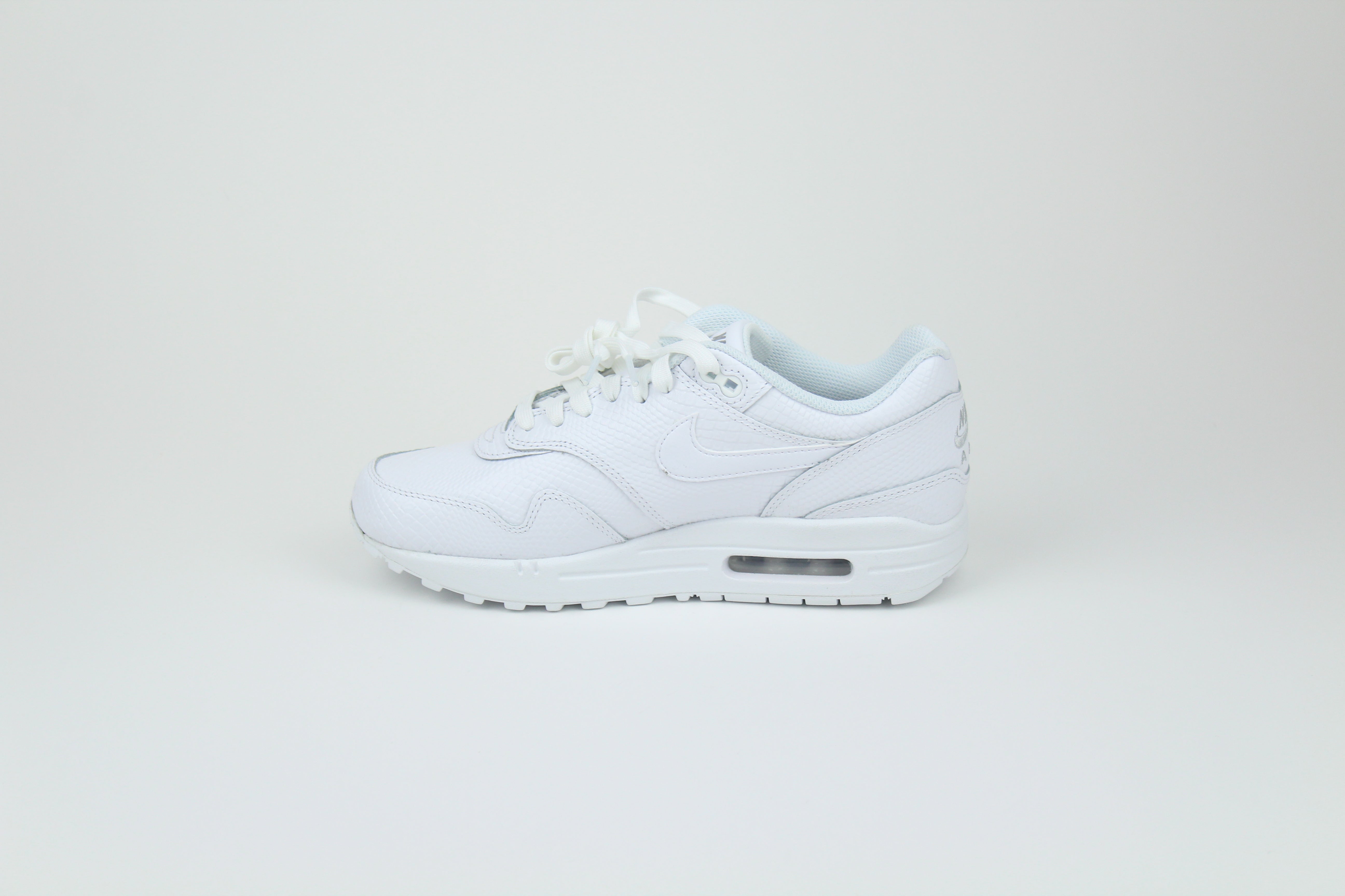 Nike Air Max 1 PRM Snakeskin sneakers in 'Triple White' colorway, premium white athletic shoes with snakeskin detailing, ideal for casual and stylish outfits.