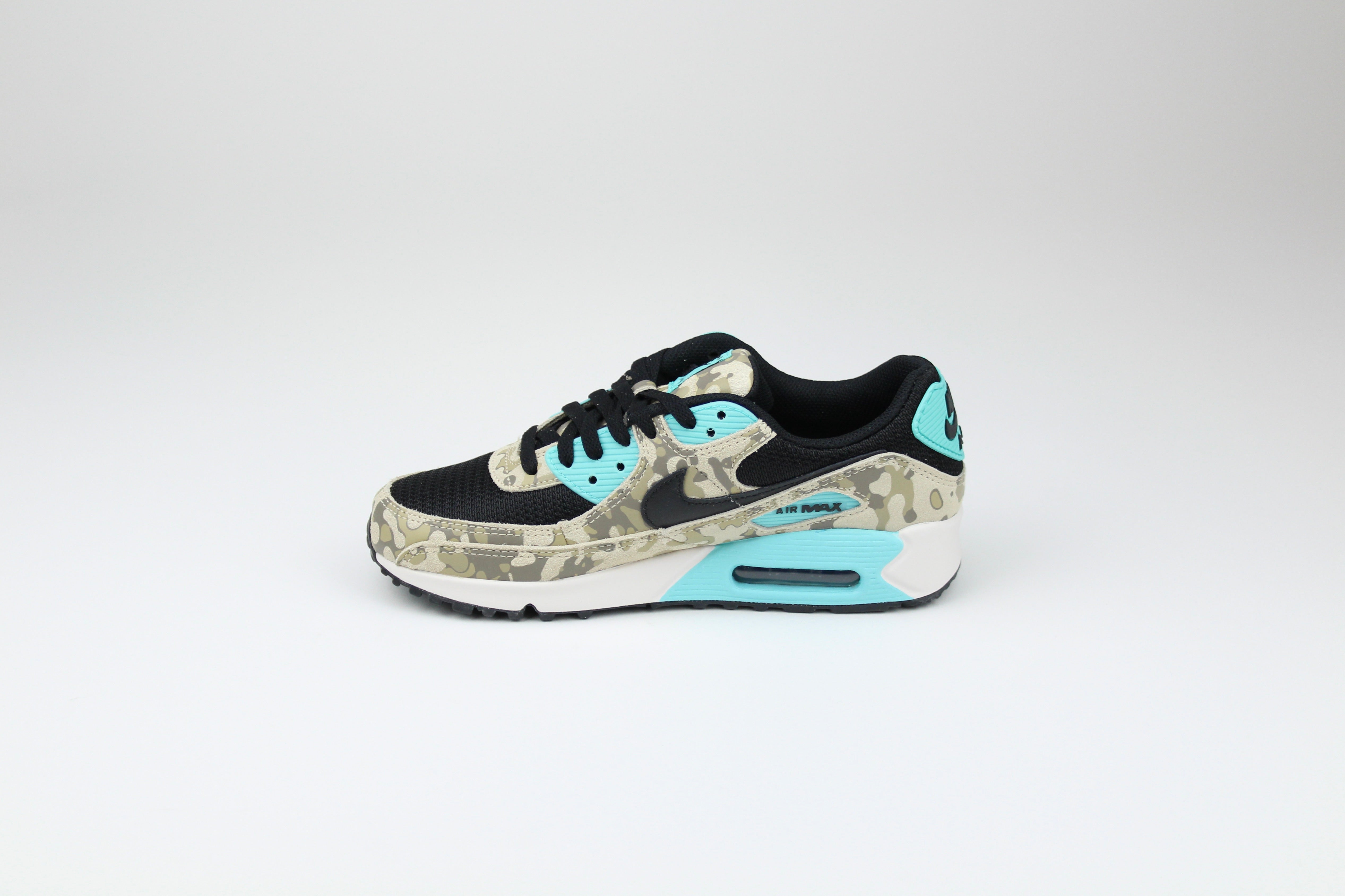 Nike Air Max 90 ‘Aurora Green’ from the 2025 Camo Pack with layered materials and bright green accents. Style with cargos and clean layers for rugged yet polished streetwear.