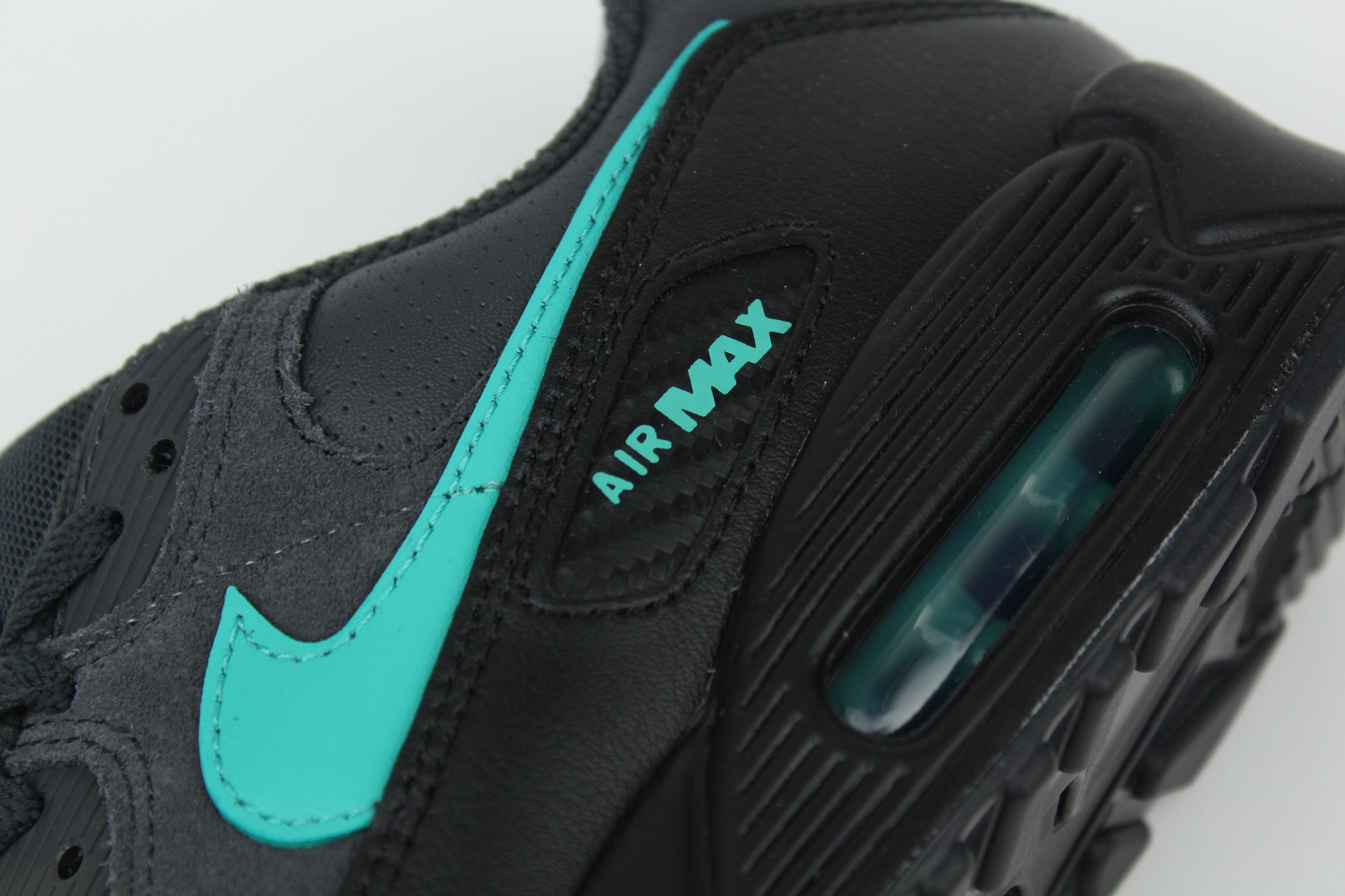 Nike Air Max 90 sneakers in 'Black Tiffany' colorway, bold black and Tiffany blue athletic shoes, perfect for casual and sporty styles.