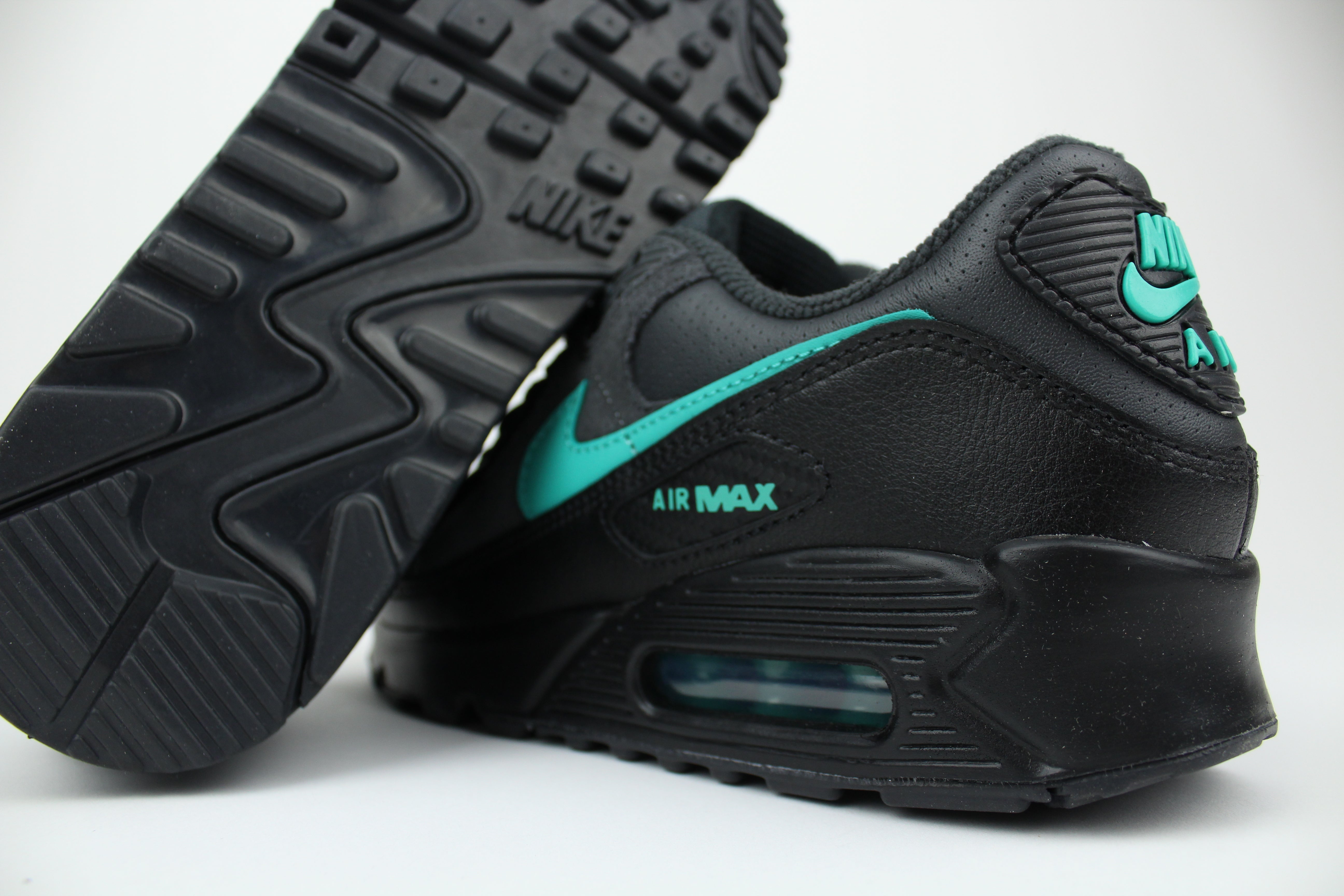 Nike Air Max 90 sneakers in 'Black Tiffany' colorway, bold black and Tiffany blue athletic shoes, perfect for casual and sporty styles.