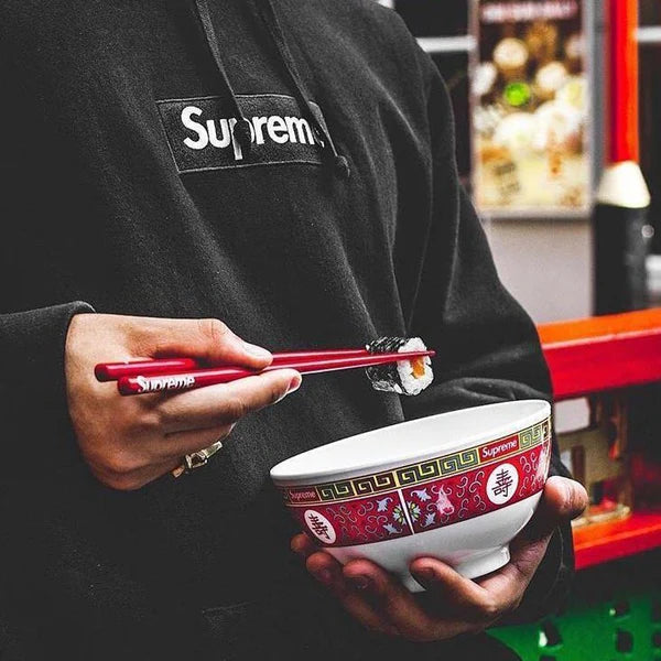 Red Supreme chopsticks from Fall Winter 2017 with white Supreme logo, minimalist plastic design.