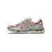 Side view of a cream and brownish-pink Asics GEL-NYC sneaker with mesh panels, suede overlays and a visible gel cushioning unit in the heel, toe pointing left