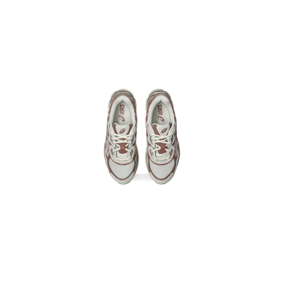 Top-down view of a pair of cream and brown Asics GEL-NYC sneakers with pink Asics branding on the tongue, laid side by side facing upward.