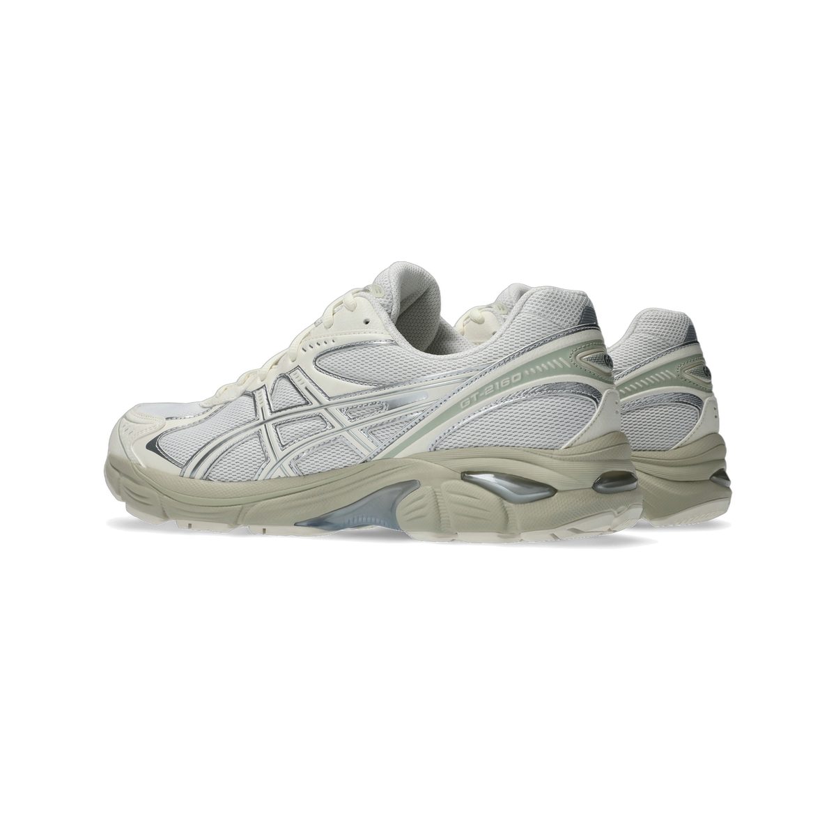 Side view of a pair of Asics GT-2160 sneakers in white and cream with silver overlays and sage green accents on the heel
