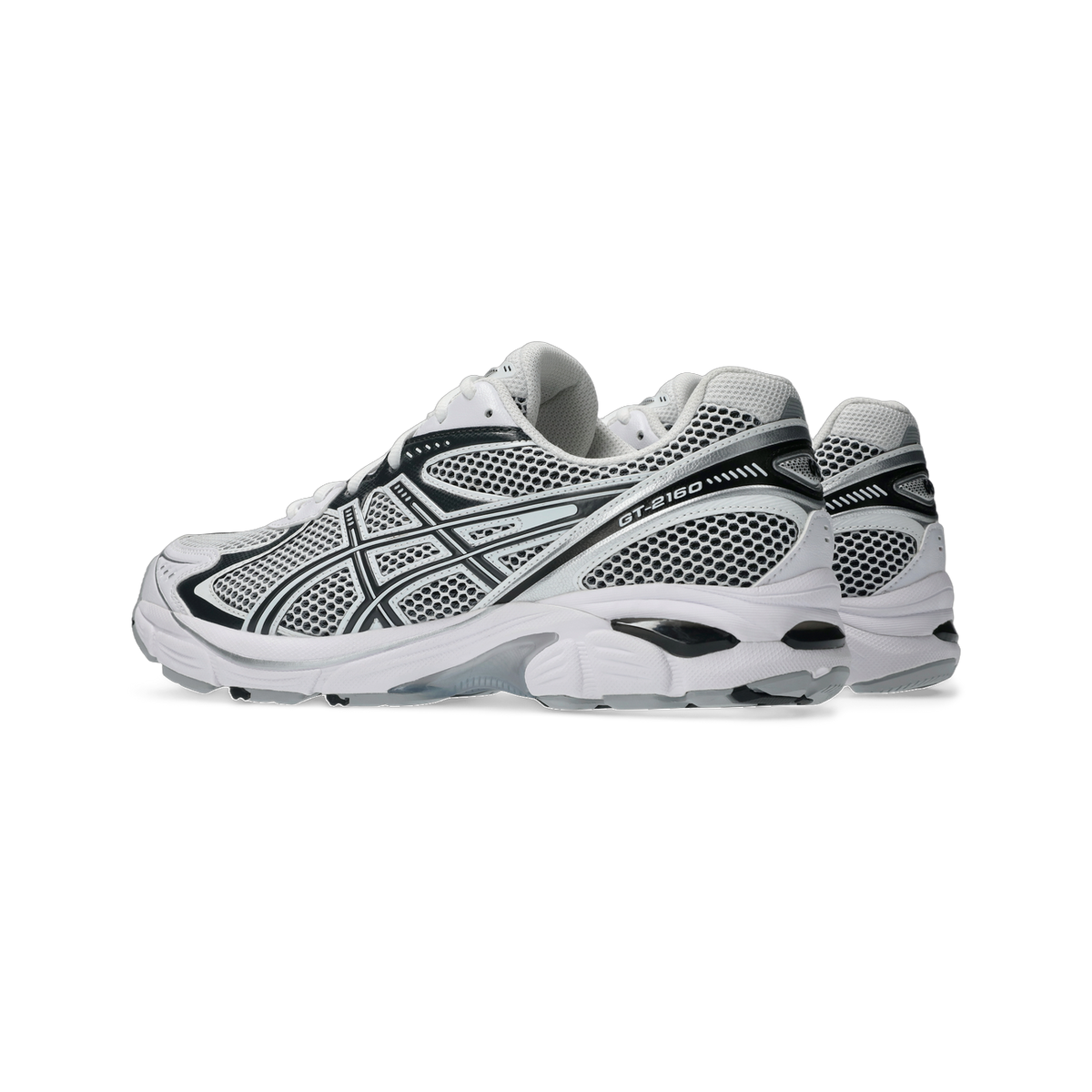 Side view of a pair of white and black Asics GT-2160 sneakers with mesh upper and grey outsole, arranged heel to toe.