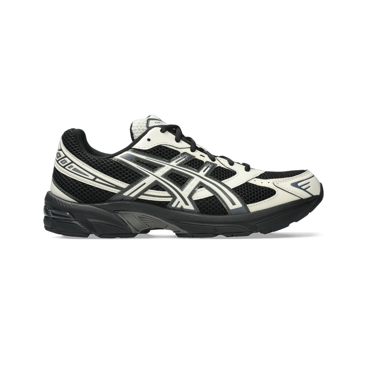 Side view of a black and white Asics Gel-1130 running shoe with mesh upper and black midsole.