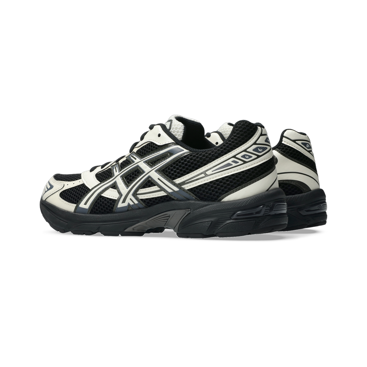 Side view of a black and white Asics Gel-1130 sneaker with mesh upper, layered synthetic overlays, and a black chunky outsole.