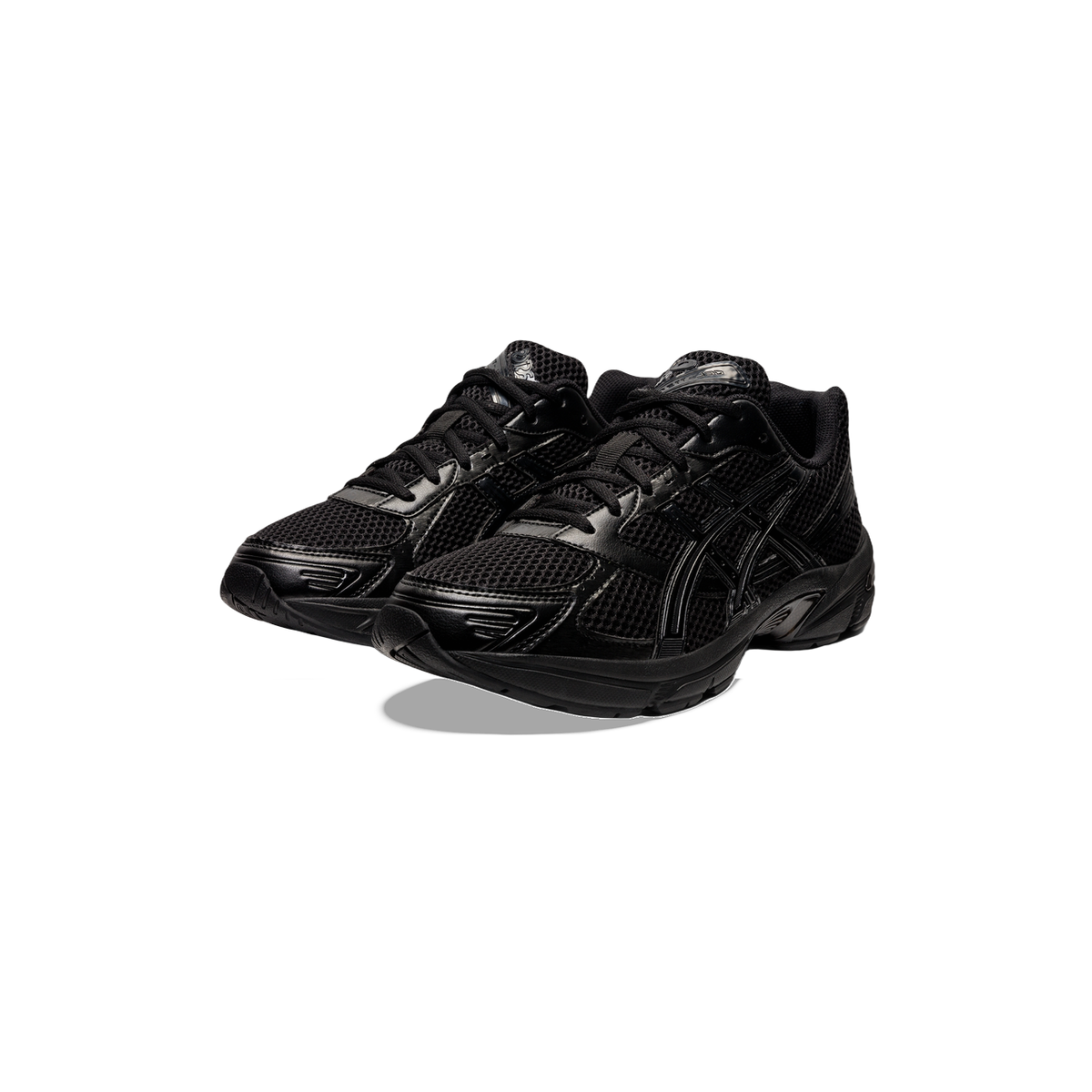 Pair of all-black Asics Gel-1130 sneakers with mesh uppers and criss-cross overlay stripes, shown at an angled front view.