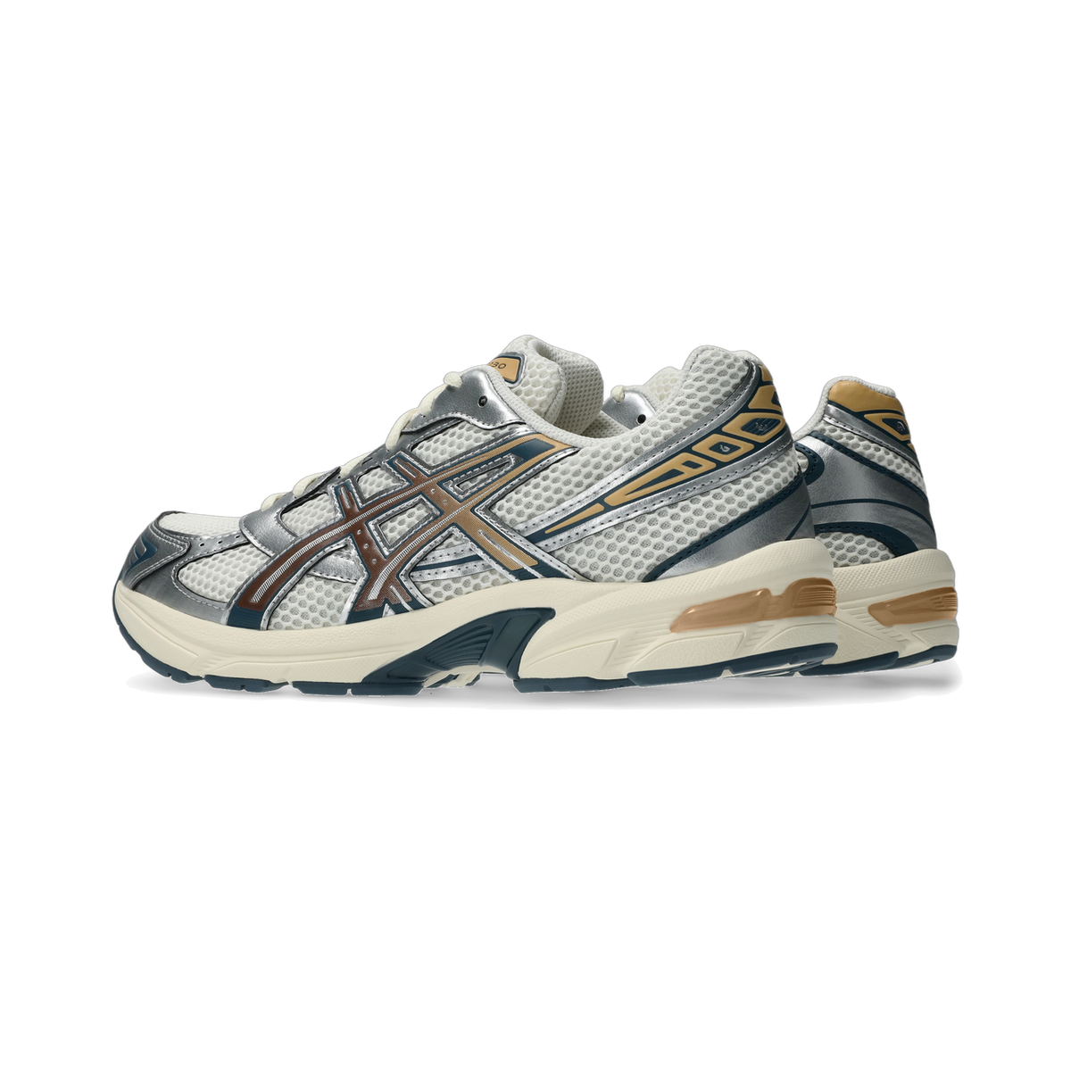 Side view of a cream and silver ASICS Gel-1130 sneaker with brown mesh overlays, gold accents, and a cream midsole, with a second shoe partially visible behind it.