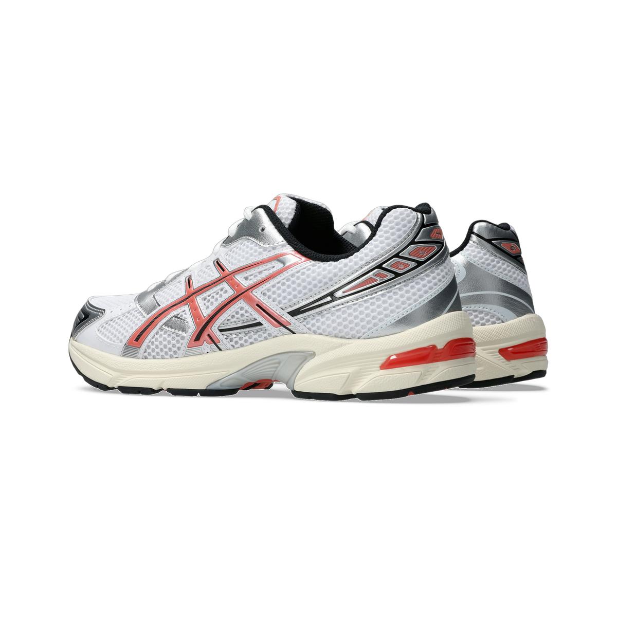 Pair of white Asics Gel-1130 sneakers with red side stripes and silver overlays, shown from the side with the rear shoe visible behind the front shoe.