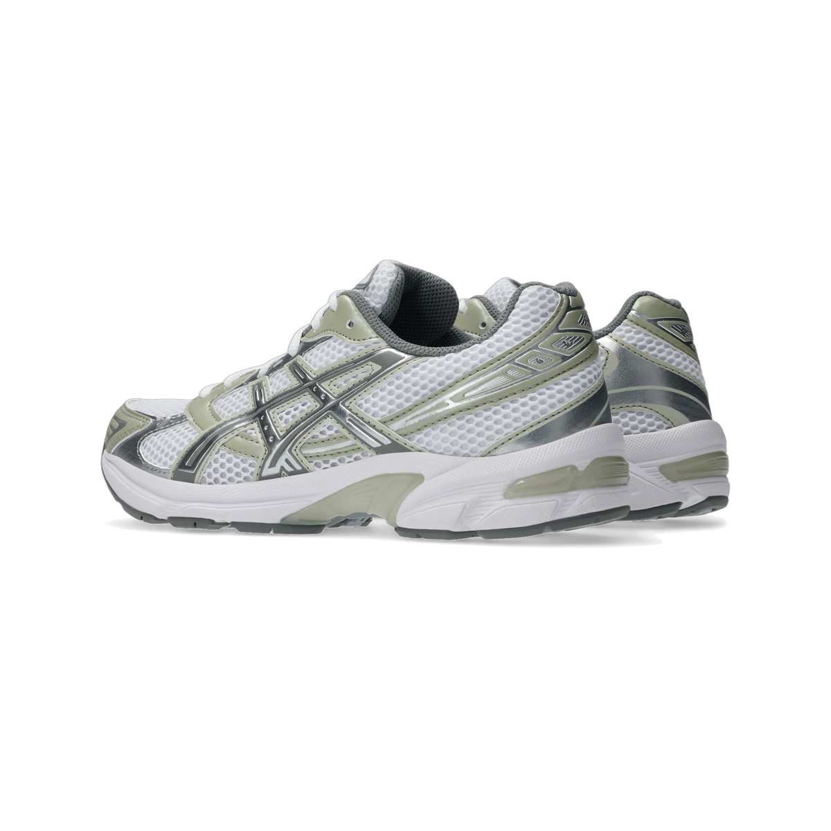 Side view of a white and sage green ASICS Gel-1130 running shoe with silver overlays and a chunky white midsole, shown with a second shoe partly visible behind it.