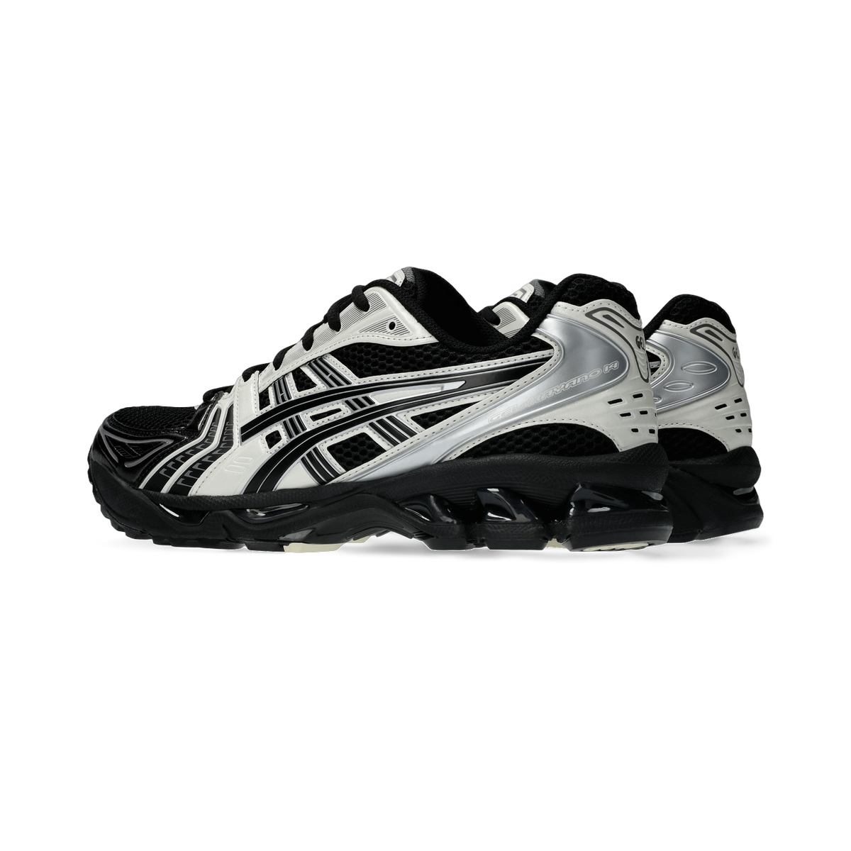Side view of a pair of black and cream Asics Gel-Kayano 14 sneakers with silver overlays and chunky black outsoles.