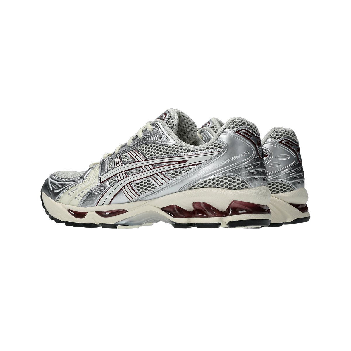 Side view of a pair of Asics Gel-Kayano 14 sneakers in silver and cream with maroon accents and a cream and burgundy translucent gel sole unit