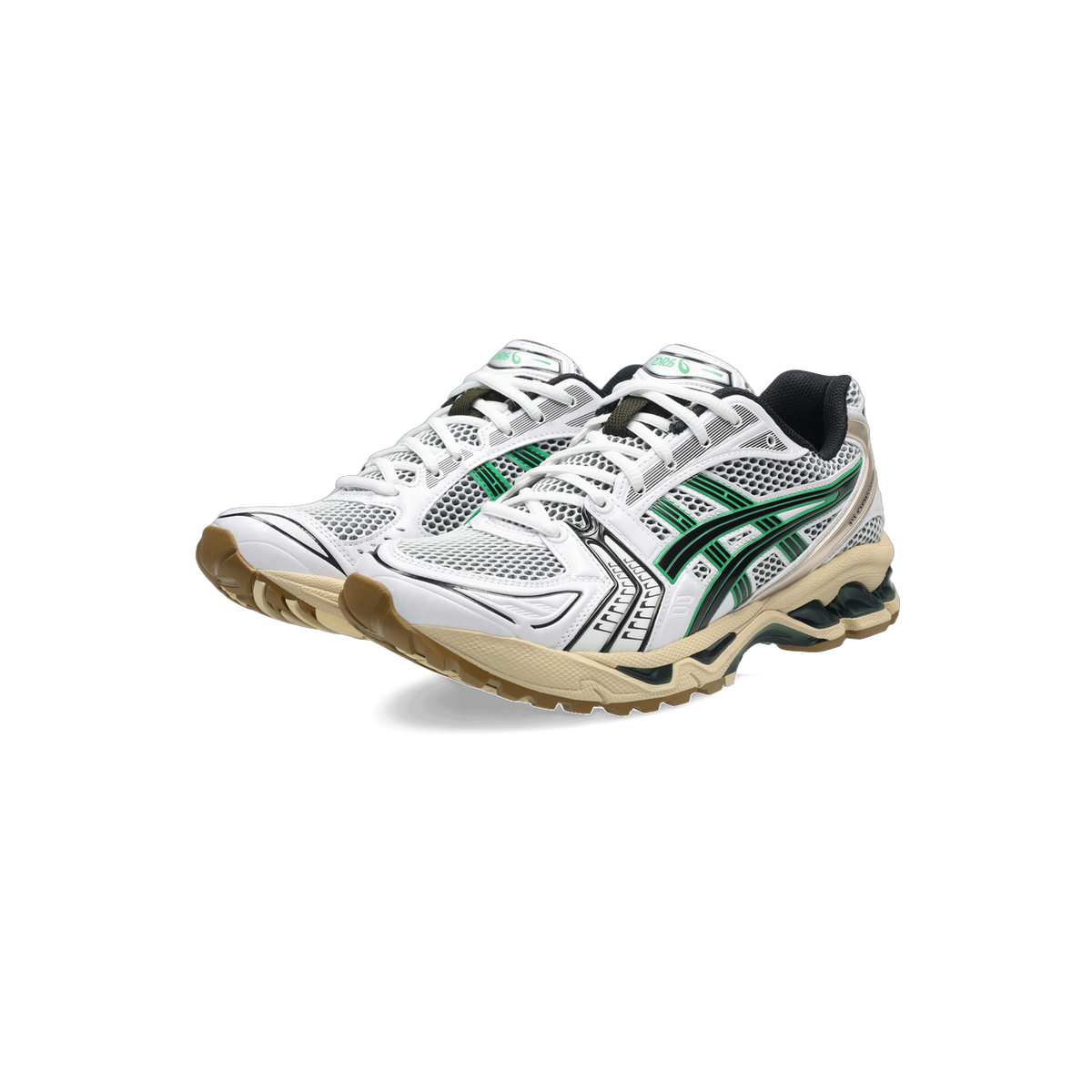 Pair of white Asics Gel-Kayano 14 sneakers with green mesh panels, black overlays, and a tan and gum outsole shown at an angled front view.