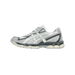 Side view of a grey and cream Asics Gel-NYC 2055 sneaker with toe pointing left, showing suede panels, mesh upper, and chunky outsole.