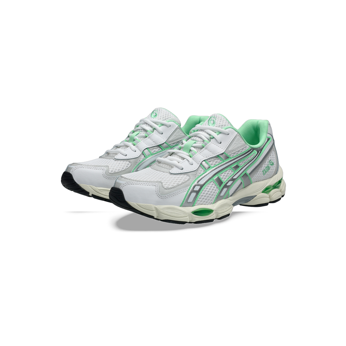 Pair of white Asics Gel-NYC sneakers with green mesh lining and silver and green side panels, shown from a front angle.
