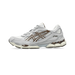 Lateral view of an Asics Gel-NYC sneaker in grey and white with brown geometric overlays and a visible brown gel unit in the cream outsole.