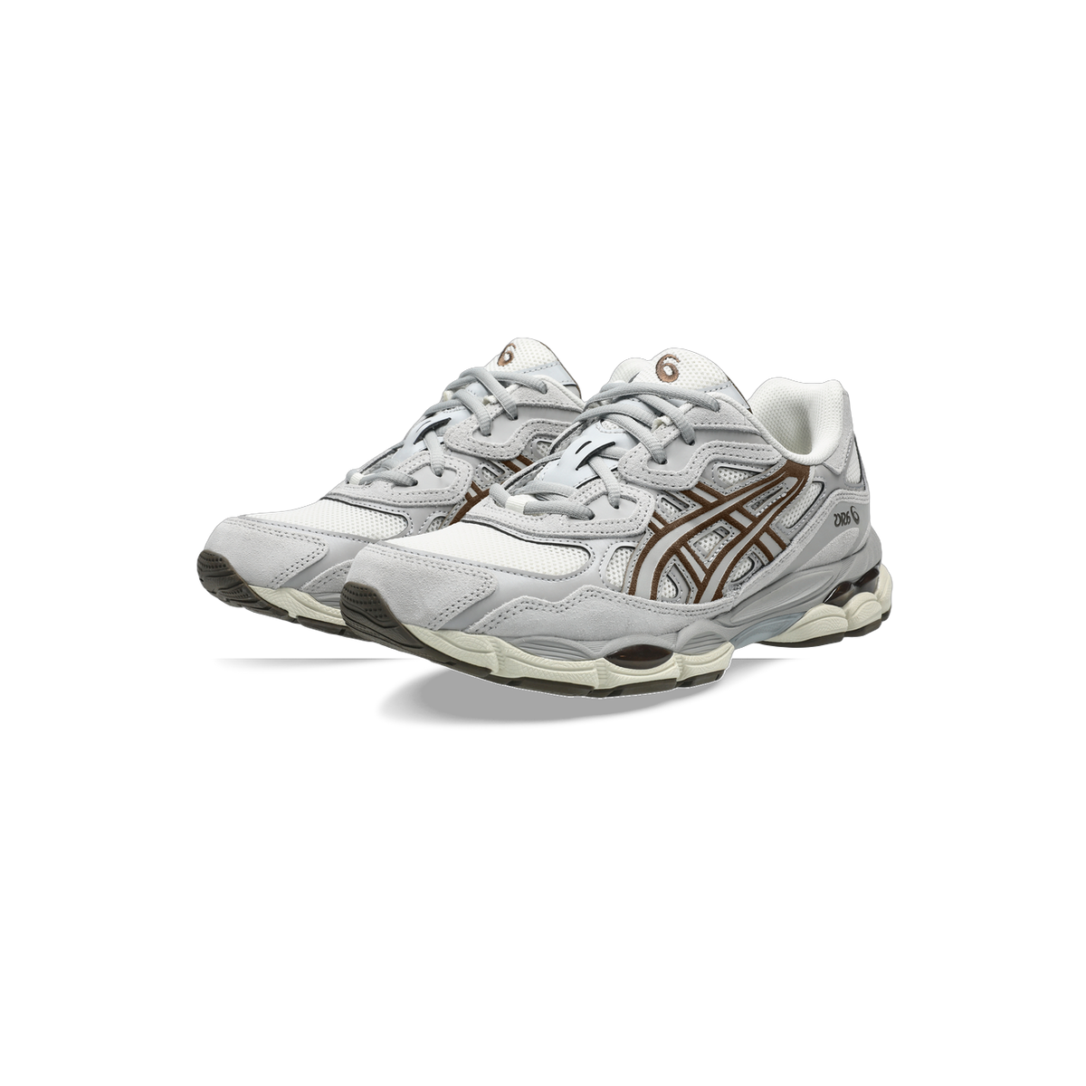 Pair of Asics Gel-NYC sneakers in cream and grey with brown lace stripe overlays, shown at an angled front view.
