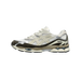 Side view of a cream and white Asics Gel-NYC sneaker with dark brown suede overlays and visible gel cushioning in the heel, toe pointing left
