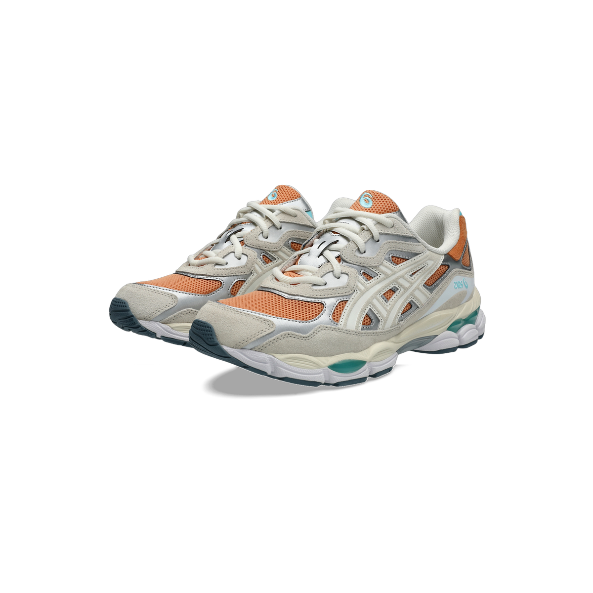 Pair of Asics Gel-NYC sneakers in orange, cream, and silver with teal gel cushioning visible at the heel, shown at a three-quarter angle.