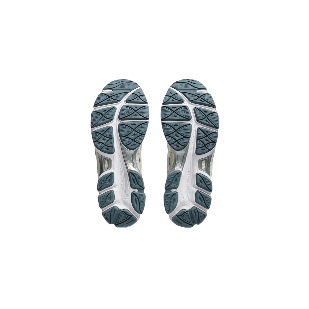 Bottom view of a pair of Asics Gel-NYC sneakers showing white and slate-blue tread patterns on the outsoles.