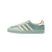 Light blue Adidas Gazelle Indoor sneaker with cream three stripes and a woven cotton texture upper, shown from the outside with toe pointing left.