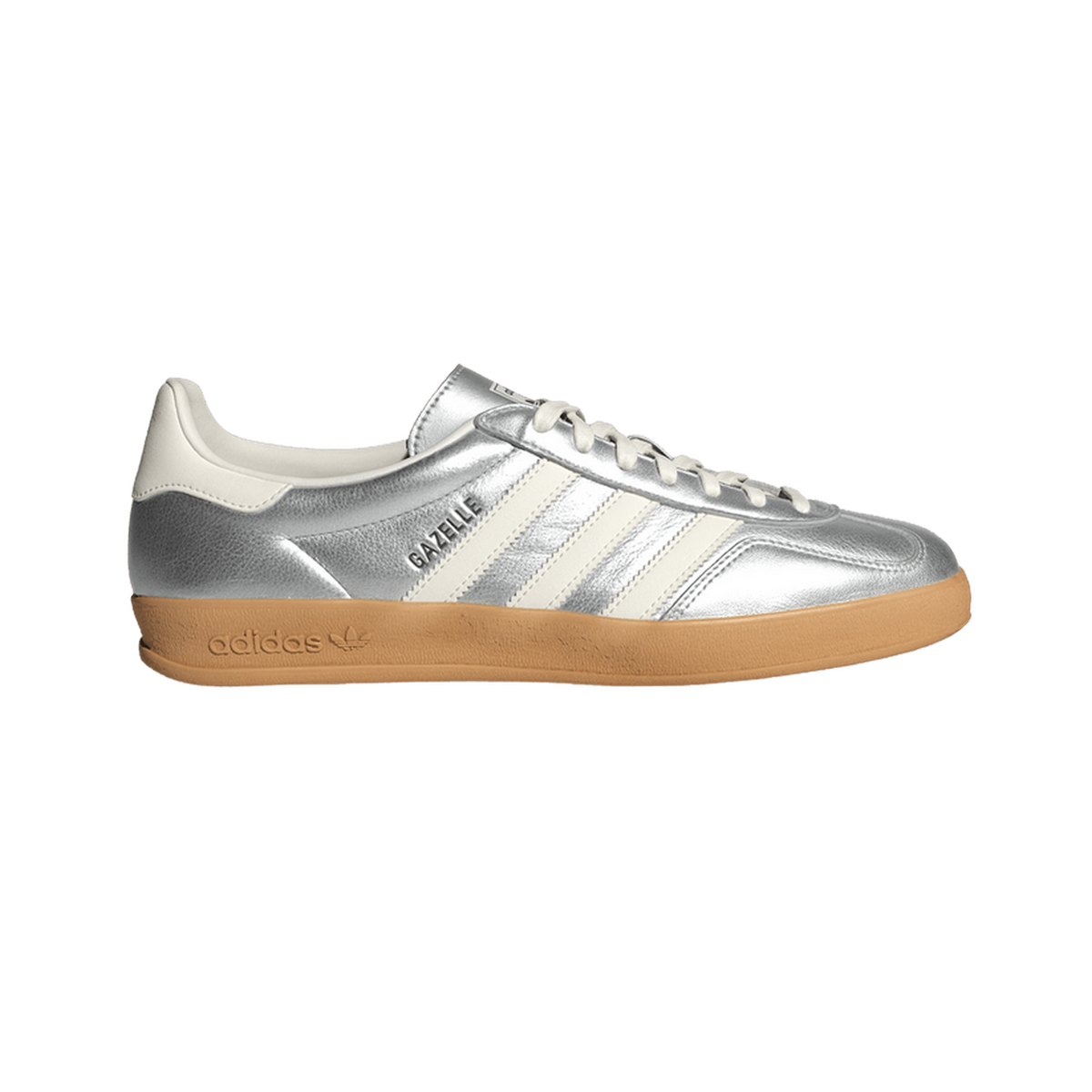 Right shoe of a silver metallic adidas Gazelle Indoor sneaker shown with toe pointing right, revealing white stripes, white heel lining, and a gum outsole, with the Gazelle branding appearing mirrored.