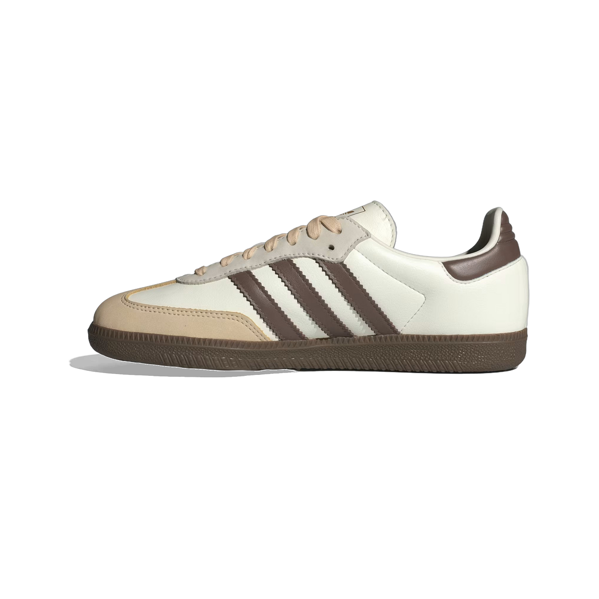 Side view of a white Adidas Samba OG sneaker with brown three-stripe details, tan suede toe overlay, and gum rubber sole.