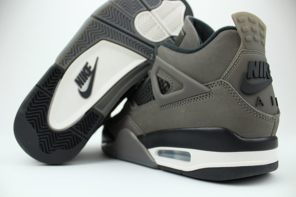 The Air Jordan 4 Cave Stone reimagines the classic silhouette with an earthy nubuck upper in taupe-brown tones, contrasted by bold black mesh and details. Travis Scott vibes.