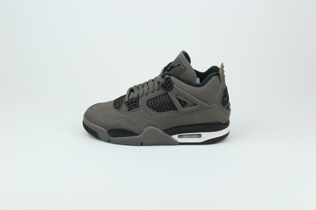 The Air Jordan 4 Cave Stone reimagines the classic silhouette with an earthy nubuck upper in taupe-brown tones, contrasted by bold black mesh and details. Travis Scott vibes.