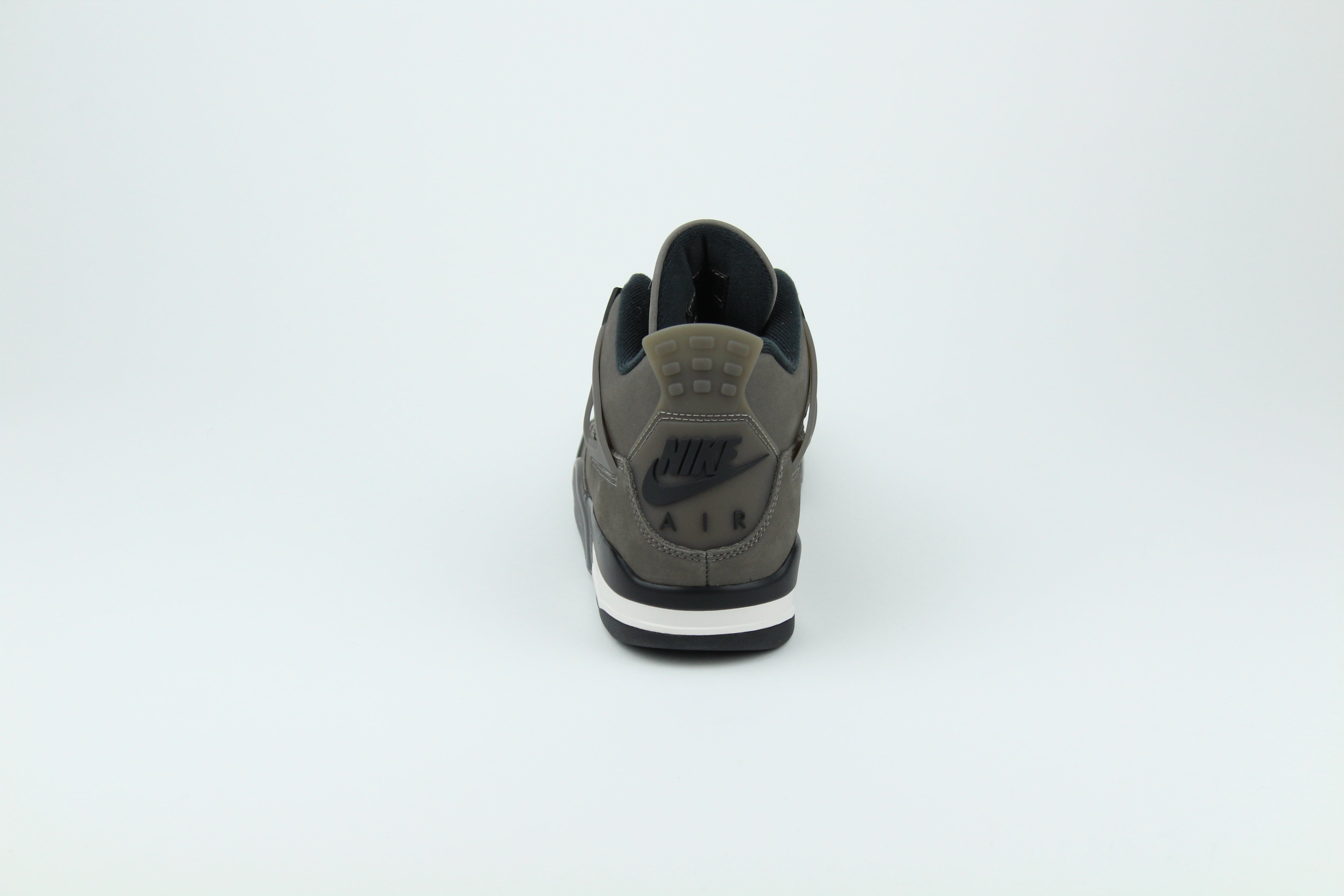 The Air Jordan 4 Cave Stone reimagines the classic silhouette with an earthy nubuck upper in taupe-brown tones, contrasted by bold black mesh and details. Travis Scott vibes.