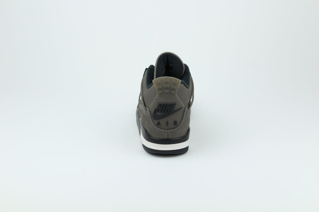 The Air Jordan 4 Cave Stone reimagines the classic silhouette with an earthy nubuck upper in taupe-brown tones, contrasted by bold black mesh and details. Travis Scott vibes.