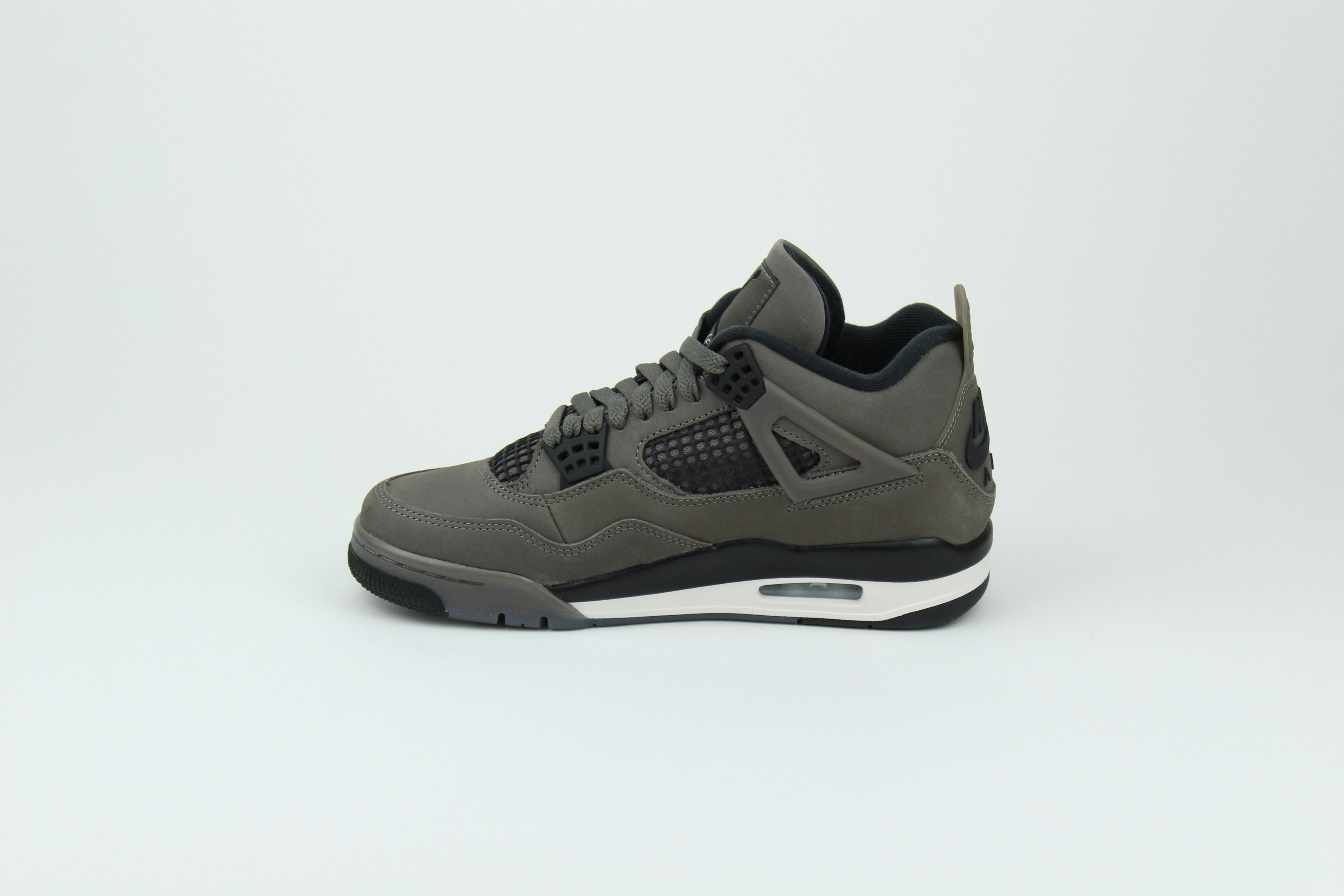 The Air Jordan 4 Cave Stone reimagines the classic silhouette with an earthy nubuck upper in taupe-brown tones, contrasted by bold black mesh and details. Travis Scott vibes.