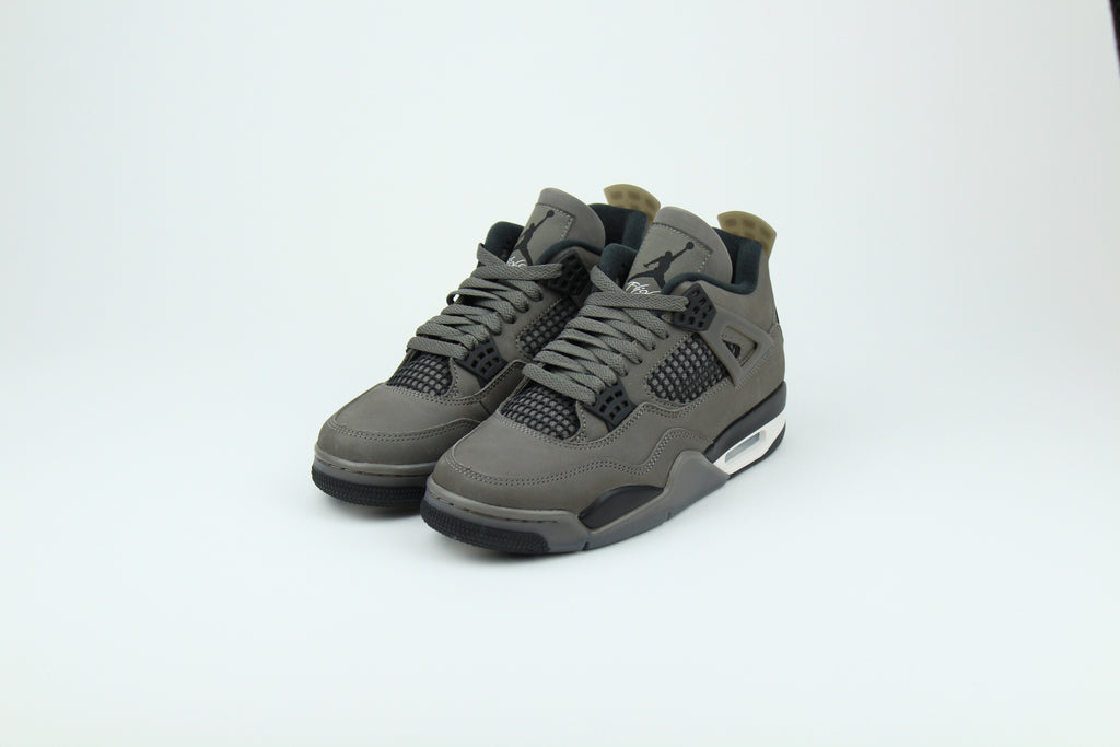 The Air Jordan 4 Cave Stone reimagines the classic silhouette with an earthy nubuck upper in taupe-brown tones, contrasted by bold black mesh and details. Travis Scott vibes.