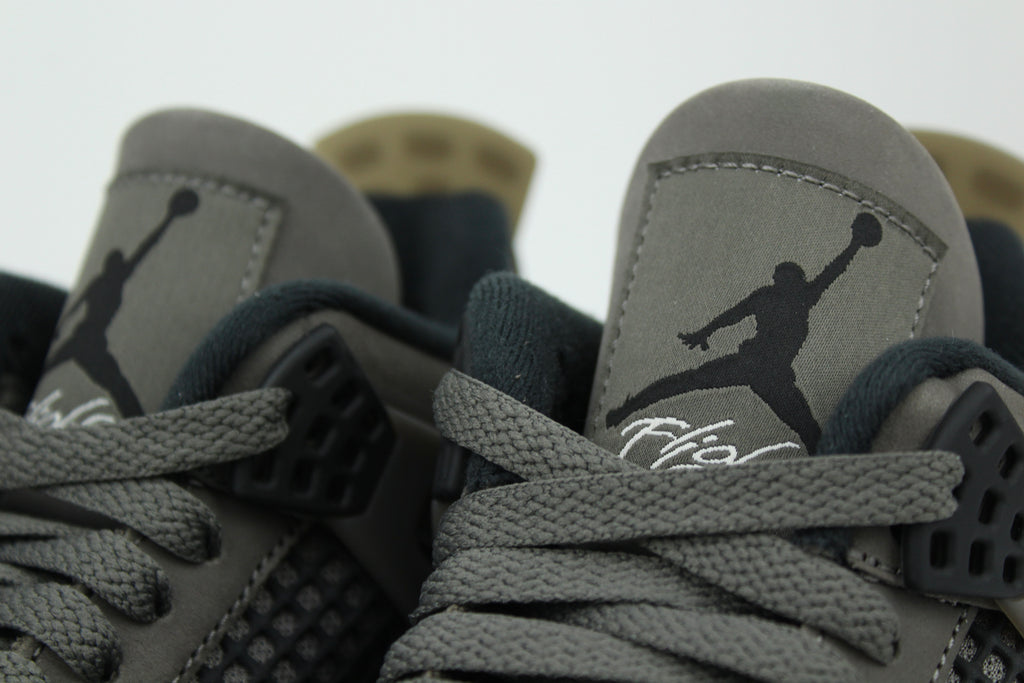 The Air Jordan 4 Cave Stone reimagines the classic silhouette with an earthy nubuck upper in taupe-brown tones, contrasted by bold black mesh and details. Travis Scott vibes.