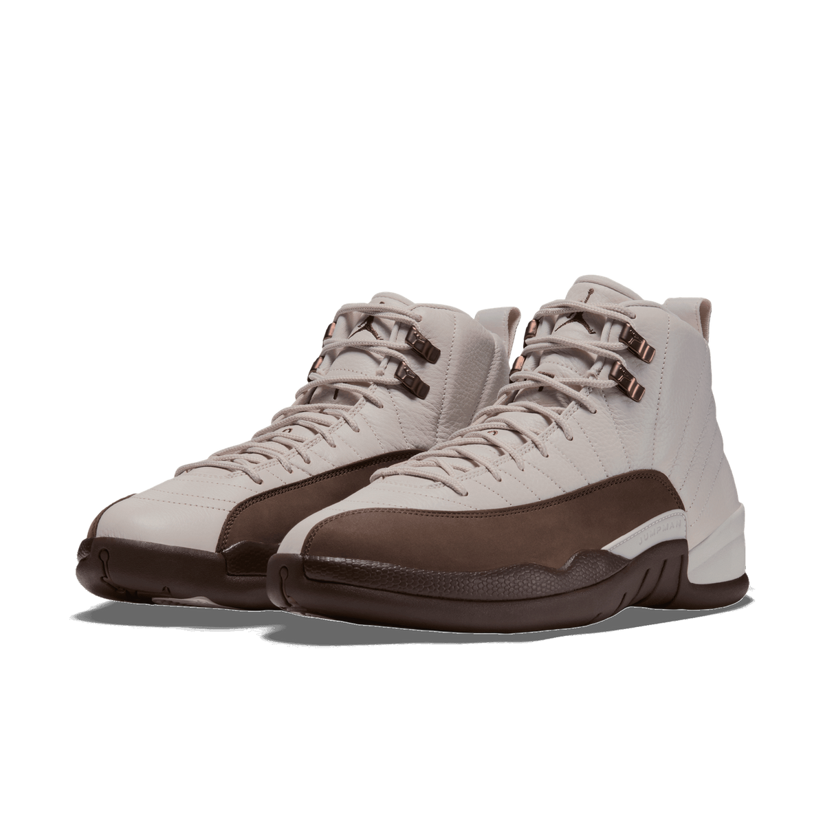 Pair of Air Jordan 12 high-top sneakers in off-white leather with dark brown toe caps and heel accents, angled toward the left.