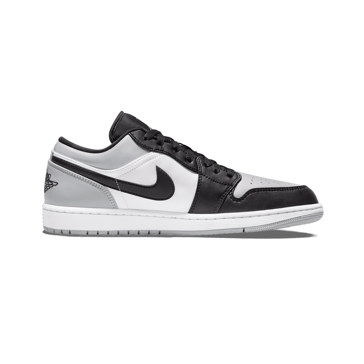 Lateral view of a black, gray, and white Air Jordan 1 Low Shadow Toe sneaker with toe pointing left, showing the black Nike swoosh and Wings logo on the heel.