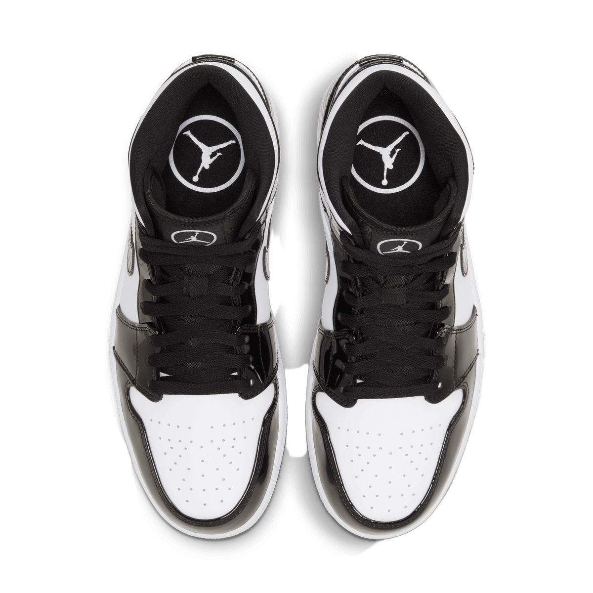 Top-down view of a pair of black and white high-top sneakers with patent leather overlays, laces untied, showing the Jordan logo on the tongue and insole.
