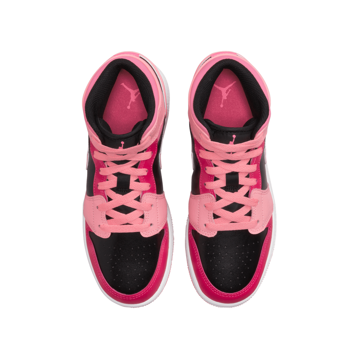 Top-down view of a pair of pink, black, and white Air Jordan 1 Mid sneakers showing the laces, tongue with Jumpman logo, and toe box.