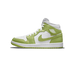 Side profile of a green and white Air Jordan 1 Mid sneaker with a green snakeskin-textured overlay, white leather panels, white laces, and the Air Jordan wings logo on the ankle, toe pointing left.