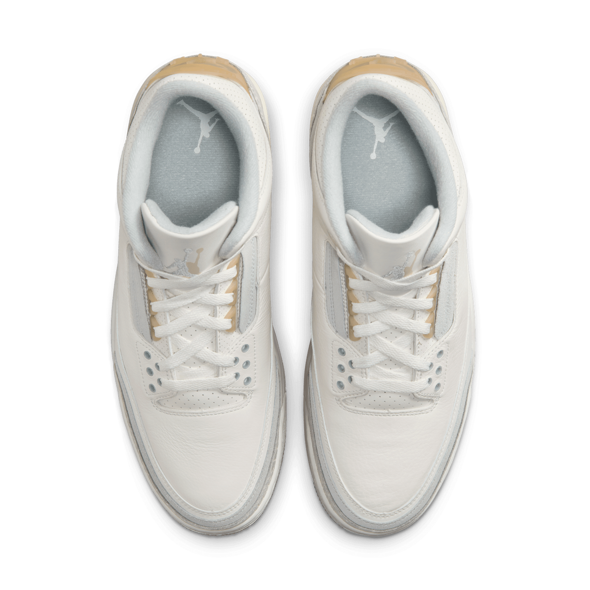 Top-down view of a pair of white Jordan 3 Retro Craft Ivory sneakers showing the laces, grey Jumpman tongue logo, and beige heel trim.