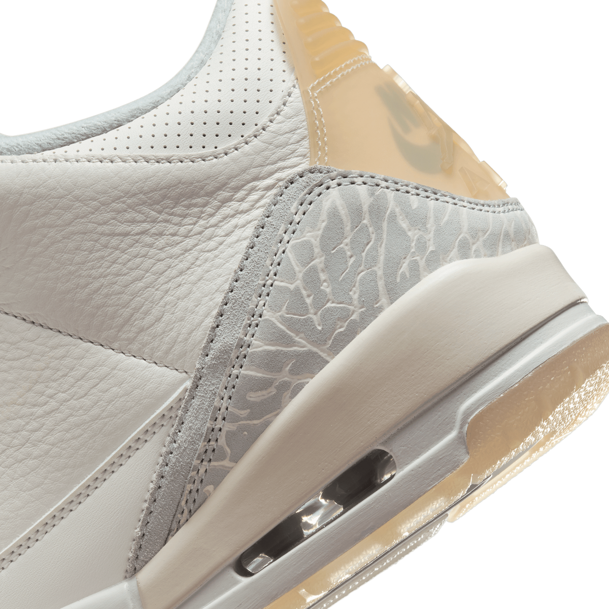 Close-up of the heel area of a white Jordan 3 showing the grey elephant print panel, perforated leather collar, and visible Air bubble sole unit.