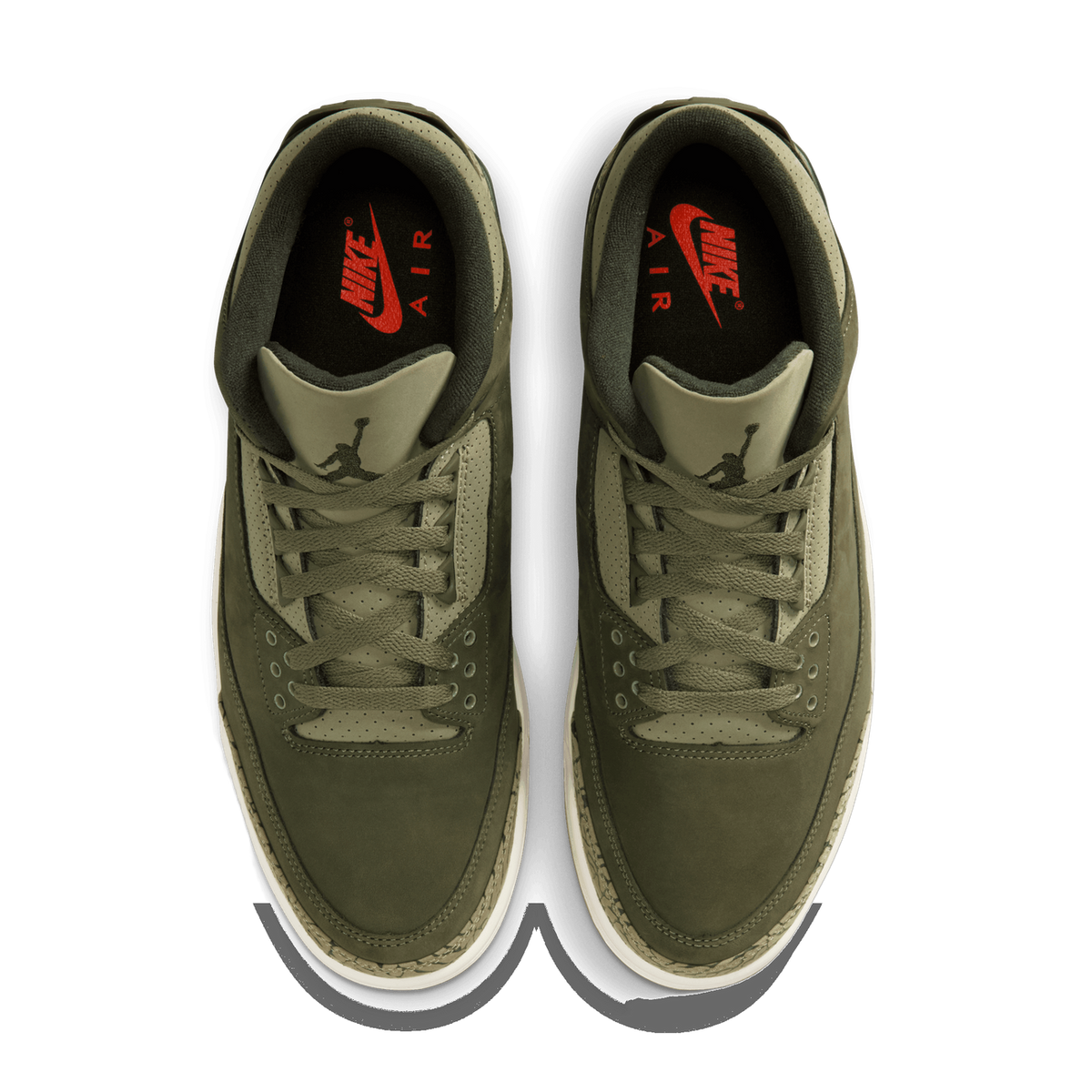 Top-down view of a pair of olive green Air Jordan 3 sneakers with tan accents, white midsoles, and red Nike Air branding visible on the tongue interior.
