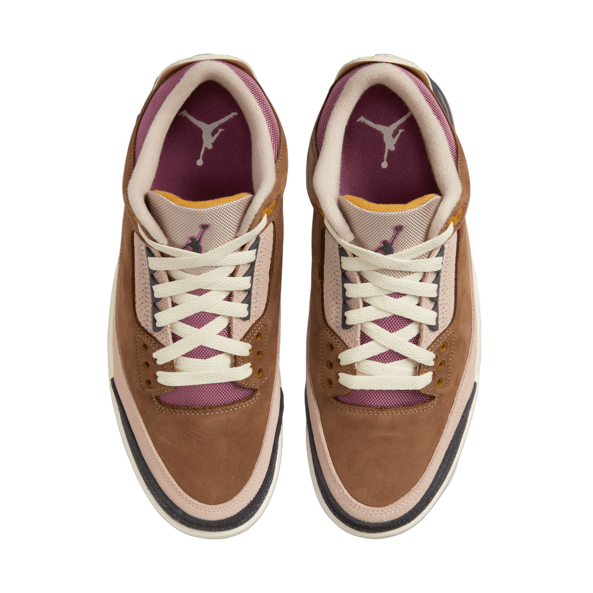 Top-down view of a pair of brown Air Jordan 3 sneakers placed side by side, showing cream laces, a burgundy-lined collar and tongue with Jumpman logos, and tan and black suede overlays.