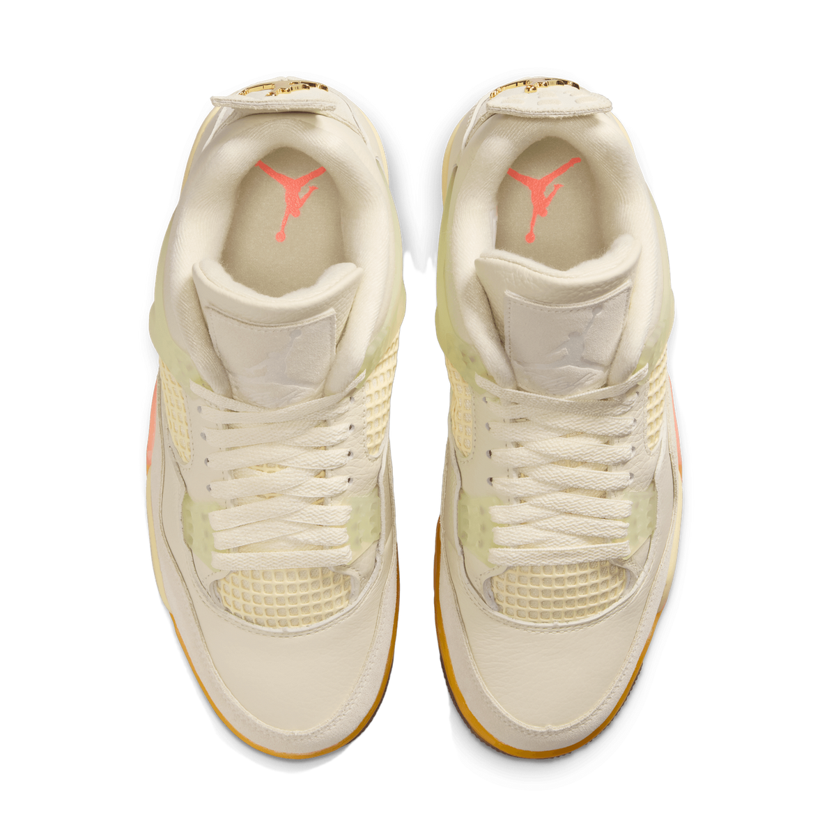 Top-down view of a pair of white Air Jordan 4 sneakers with pink Jumpman logo on the tongue, mesh side panels, gold lace eyelets, and gum soles.