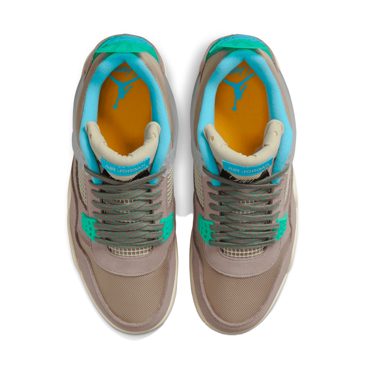 Top-down view of a pair of taupe and grey Air Jordan 4 sneakers placed side by side with toes pointing toward the viewer, showing teal and green accents, orange insole lining, and laces tied with teal-flecked detail.