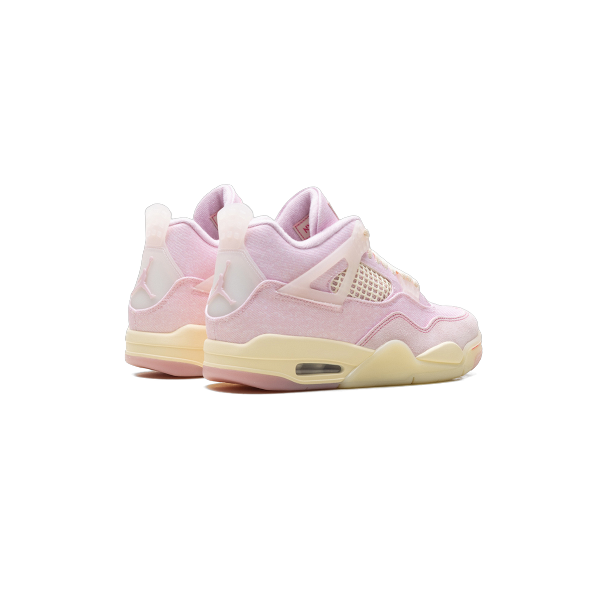 Rear angled view of a pair of pink Air Jordan 4 Retro sneakers with cream midsoles and mesh side wing detail.