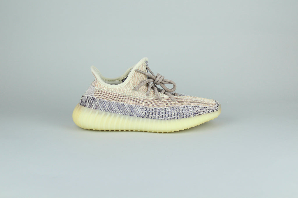 Adidas Yeezy Boost 350 V2 Ash Pearl sneakers side view, light beige and cream colors, modern design, popular sneaker collaboration, high-top athletic shoe