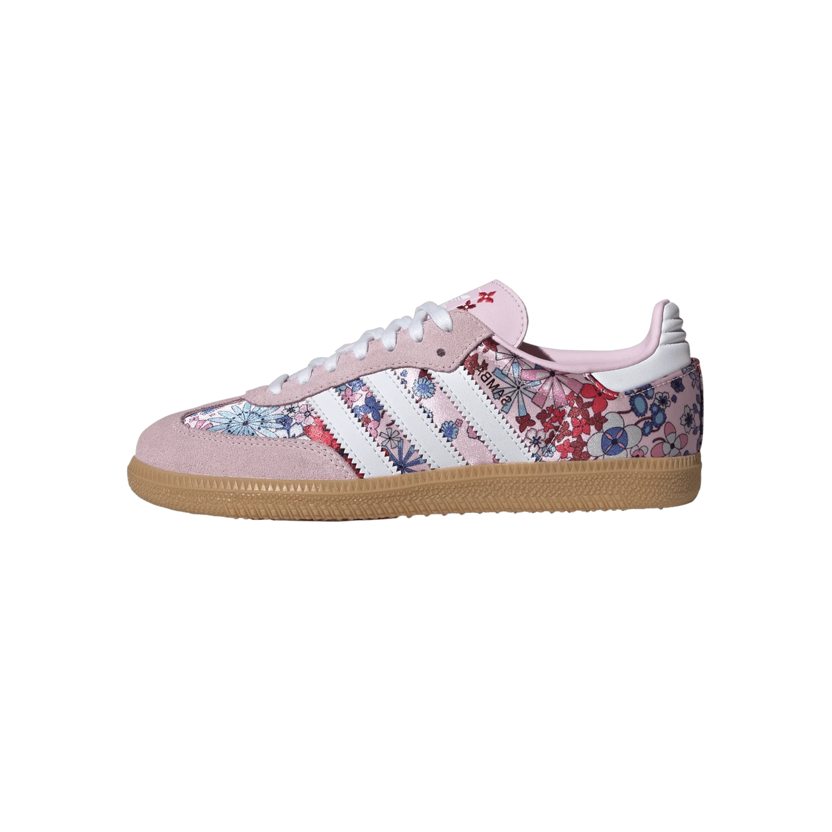 Side view of a pink Adidas Samba sneaker with floral multicolor print, white stripes, pink suede toe and heel, white laces, and a gum sole.